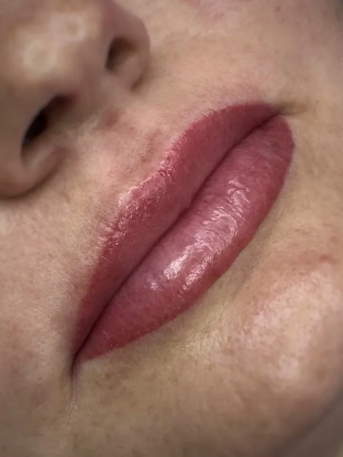 Permanent lip makeup in a natural rosy shade — side view